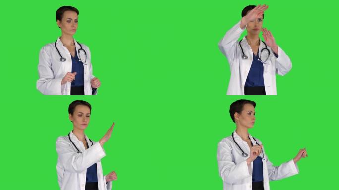 医疗保健，医学和技术概念-微笑的女医生指着某物或按下绿色屏幕上的假想按钮，色键