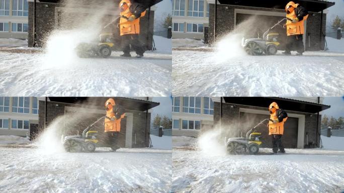 男子在冬天用扫地机清理院子里的雪