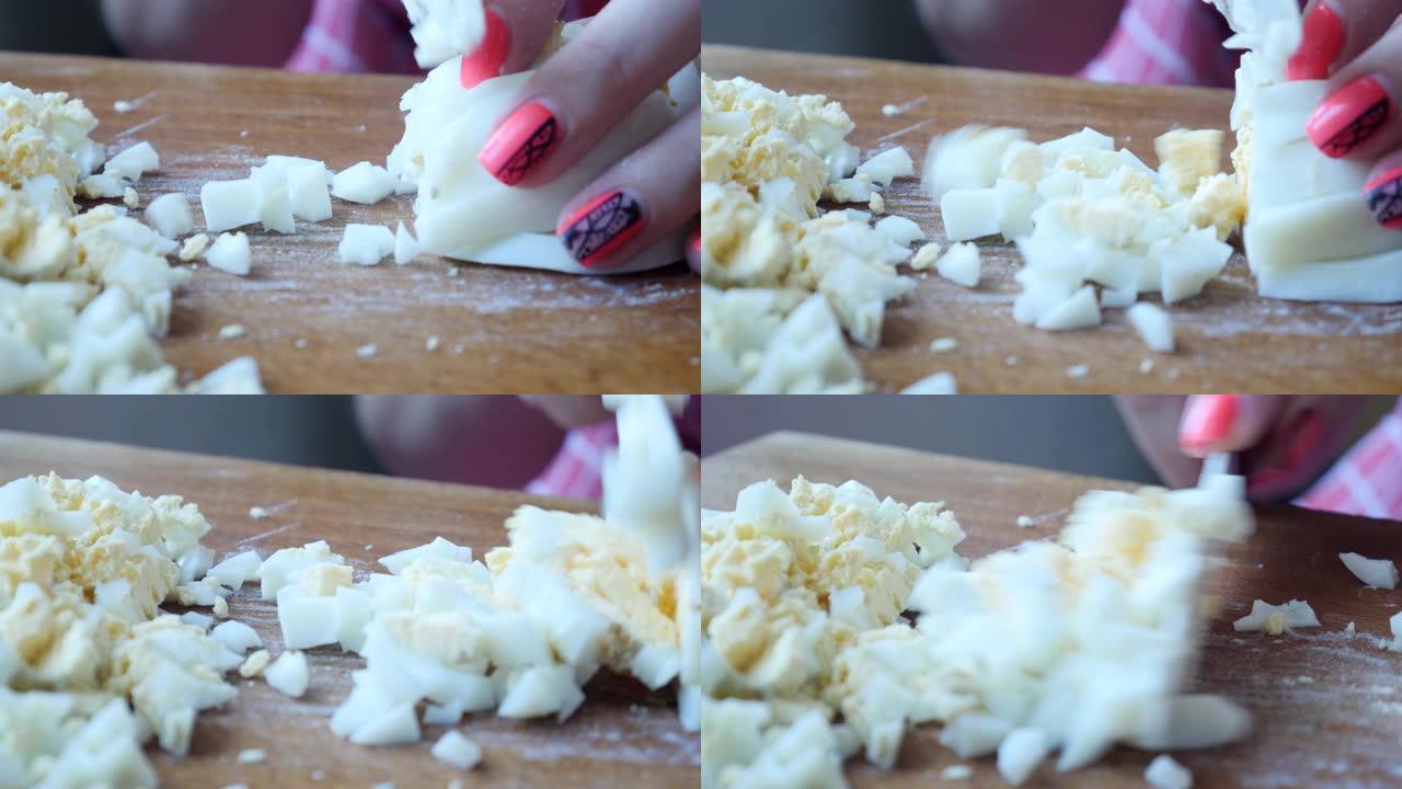 在厨房板上切煮熟的切成薄片的鸡蛋