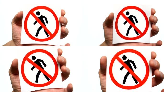 禁止行人通行禁止标志隔离。男性手持警告标志