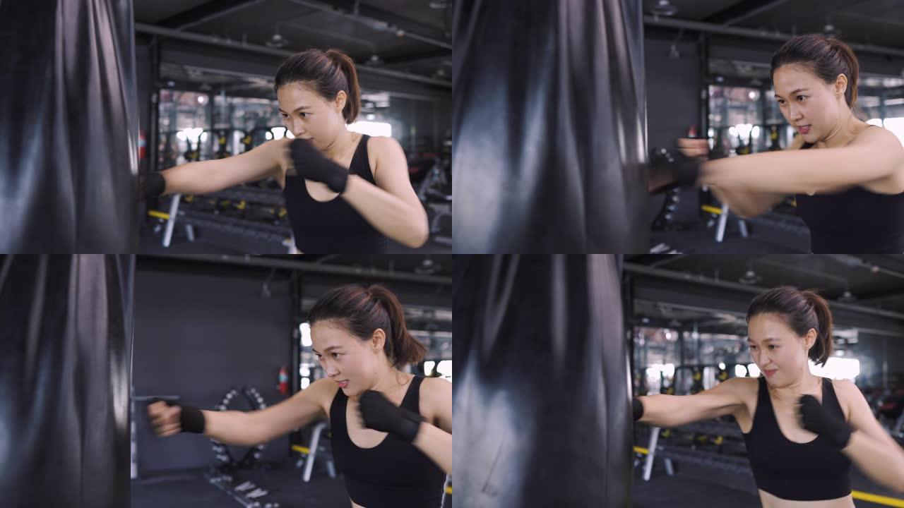 女子跆拳道练习用沙袋拳击手在健身馆练习拳击健康的生活方式，竞技体育女子训练耐力强的锻炼。4K超高清影