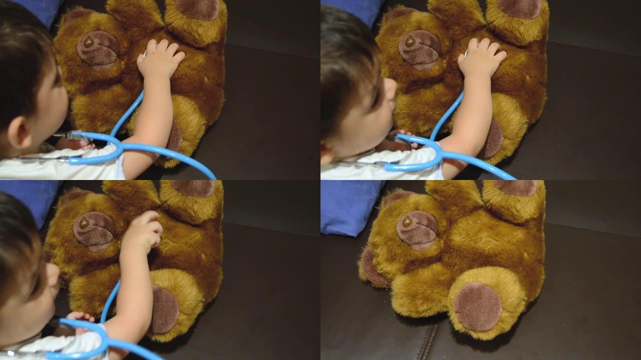 蹒跚学步的孩子在他的泰迪熊上使用听诊器