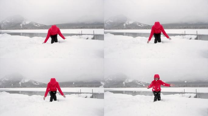 女人在朱砂湖玩雪