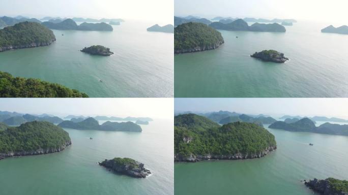 空中: 在越南著名旅游胜地下龙湾和猫巴岛上空的独特飞行。风景秀丽的天空有云，地平线上的石灰岩山峰。