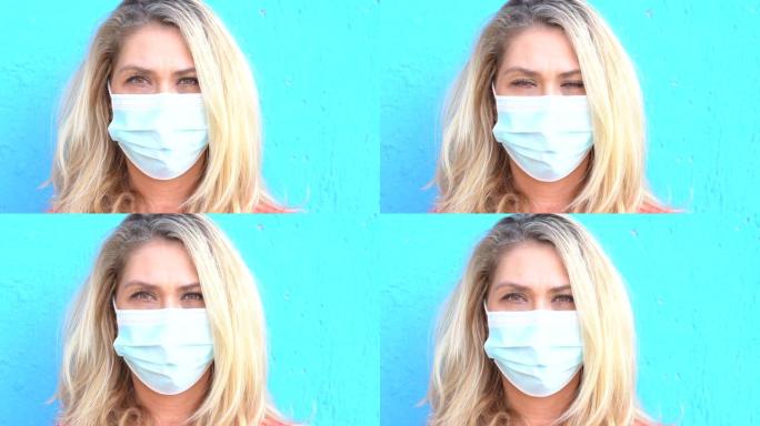 4k视频女人戴着防护面罩站在蓝色背景前