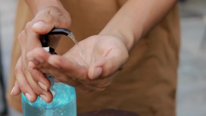 慢动作年轻女子使用酒精凝胶洗手防止病毒和细菌