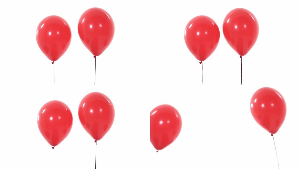 两个红色的气球。孤立，在白色背景上。