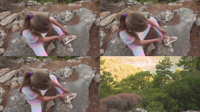 女孩在山上徒步旅行时徒步涂石膏