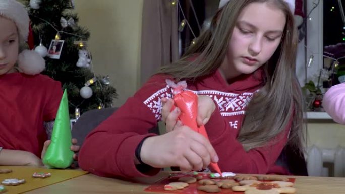 Children decorate Christmas cookies