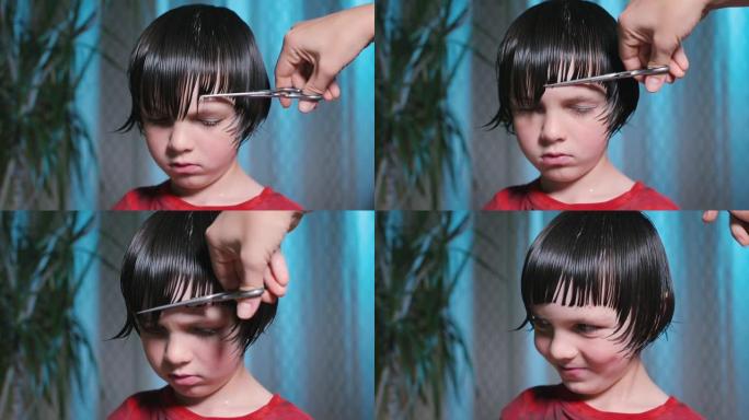理发时心烦意乱的男孩。理发师用梳子梳头。