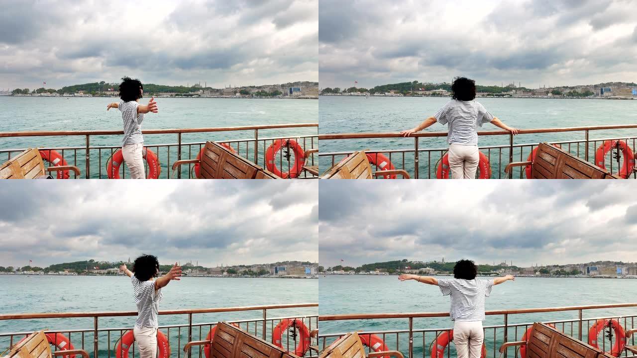 土耳其年轻女子在博斯普鲁斯海峡享受乘船游览，背景是伊斯坦布尔阿亚索非亚