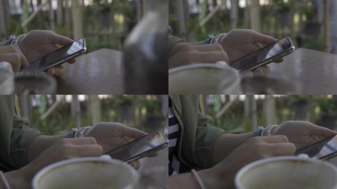 女人使用带有黑屏的智能手机。在家喝咖啡