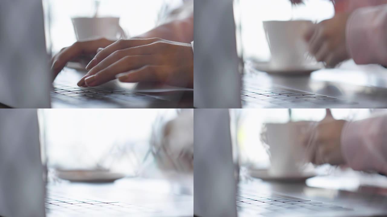 美丽的亚洲女性自由职业者使用笔记本电脑在咖啡店工作