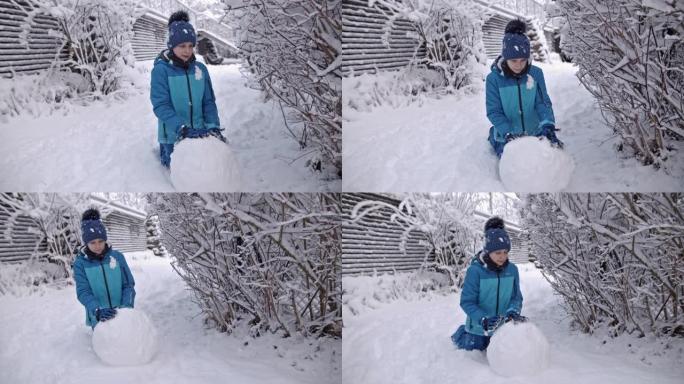 小男孩在冬天堆雪人