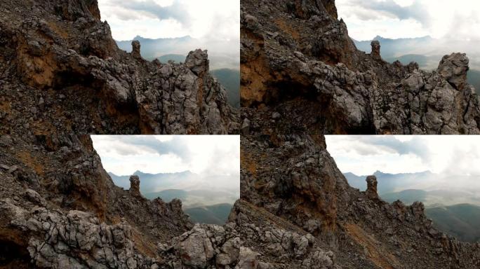 日落时无人机飞过尖锐的岩石露头的特写鸟瞰图。用于极端登山的陡峭的岩层山。飞行穿越旅行视频