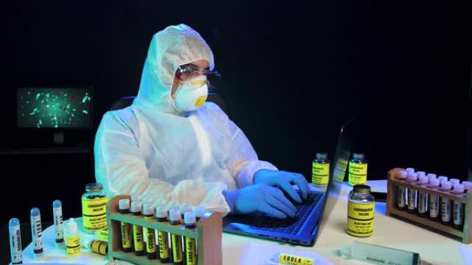 实验室科学家穿着防护服在笔记本电脑上打字，向前多莉射击