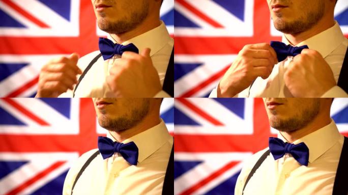 一位绅士在英国国旗的背景下拉直领结，特写。