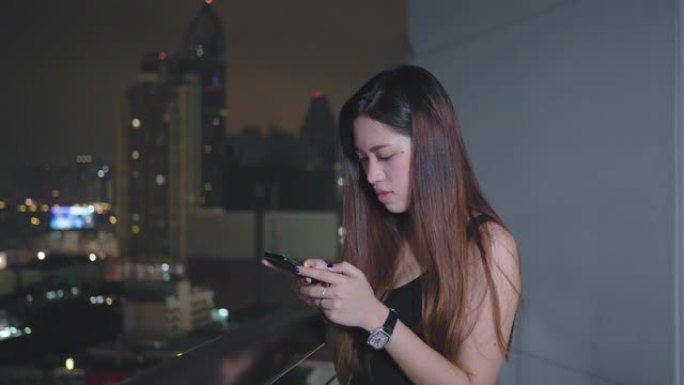 Young Asian Woman Using Smart Phone in the City at