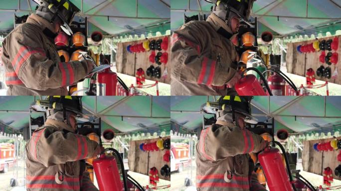 发生火灾时，亚洲消防员检查灭火器系统中的二氧化碳。工作概念的准备。慢动作