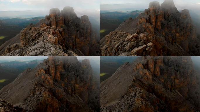 日落时无人机飞越尖锐的岩石露头的鸟瞰图。用于极端登山的陡峭的岩层山。飞行穿越旅行视频