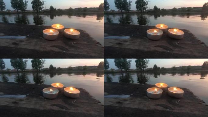 三支药丸蜡烛躺在一个旧木板码头的边缘