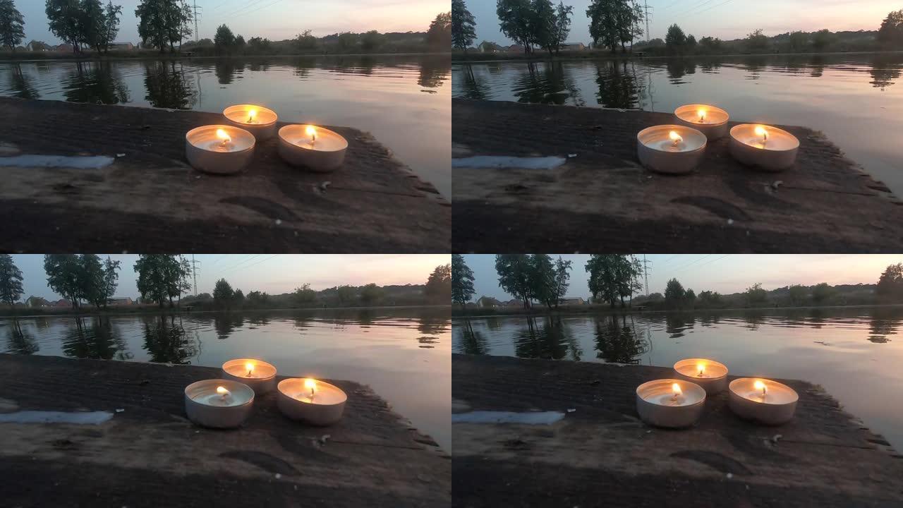 三支药丸蜡烛躺在一个旧木板码头的边缘