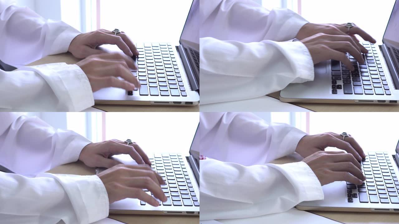 特写阿拉伯男子手型笔记本电脑键盘