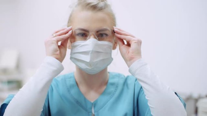 女医生脸上戴防护口罩，戴眼镜。健康护理诊所的医生