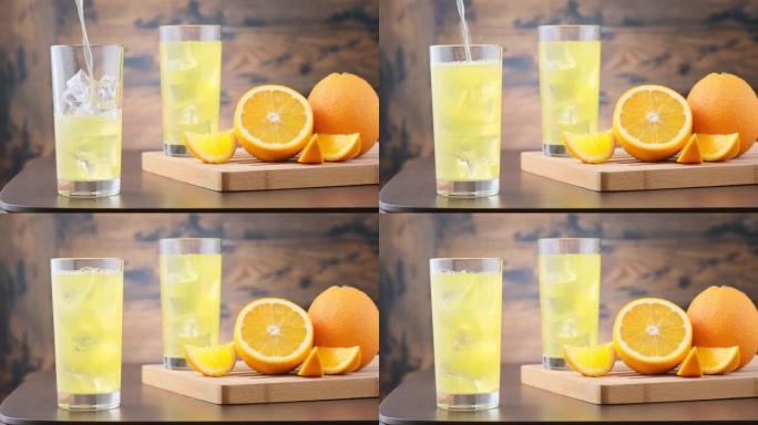 用冰块将橙色碳酸柠檬水倒入玻璃杯中。在橙色水果的木制背景上