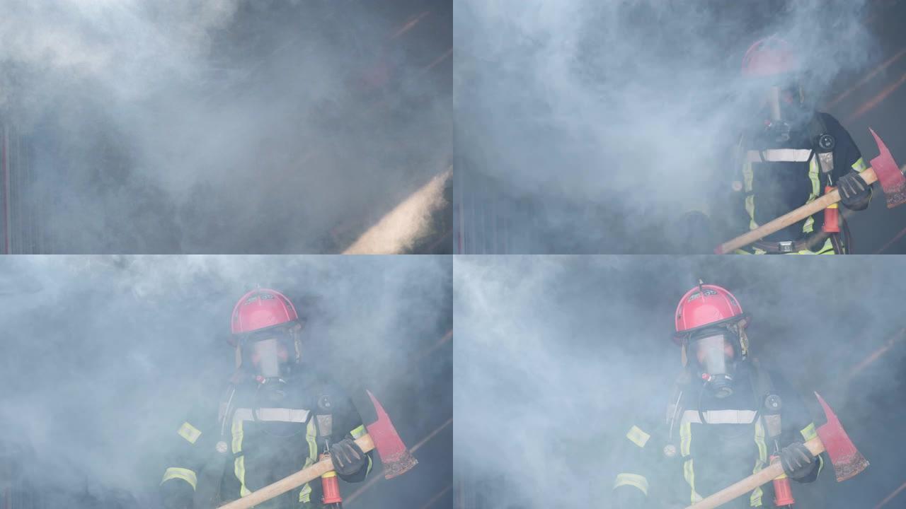 亚洲消防员手持斧头自信地穿越烟雾，背景中燃烧着烈火。消防员生涯，训练消防演练理念。慢动作。