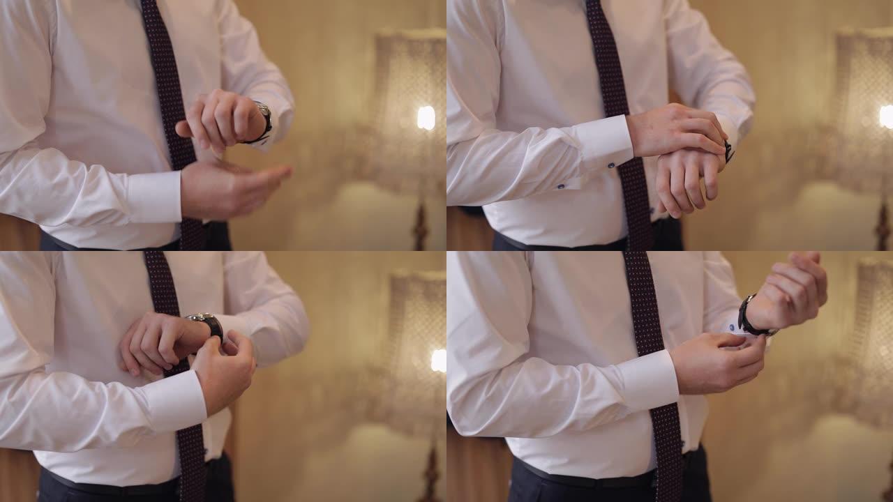 英俊的新郎修理他的时钟。白衬衫。婚礼早上。商人