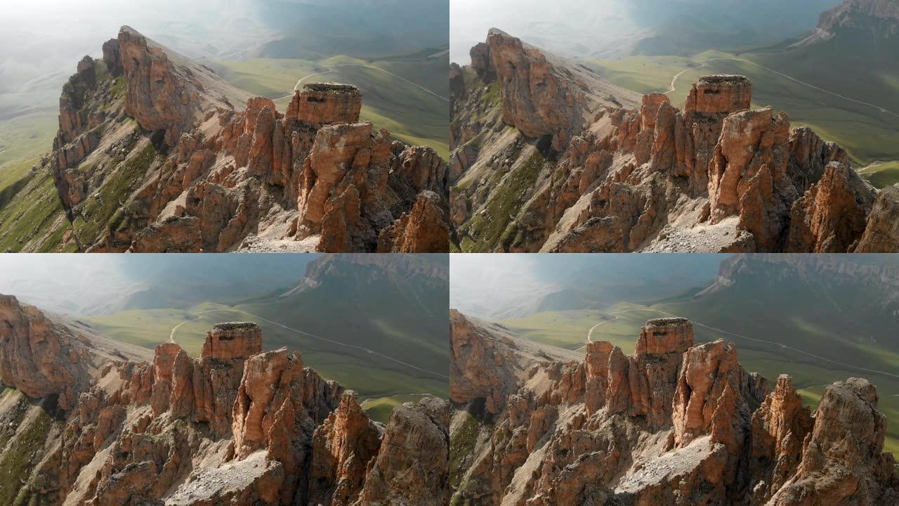 日落时无人机飞越尖锐的岩石露头的鸟瞰图。用于极端登山的陡峭的岩层山。飞行穿越旅行视频