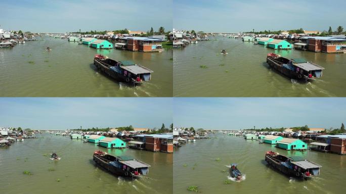 在越南南部的湄公河三角洲，漂浮的Chau Doc村和一艘航行在Bassac河上的船在阳光明媚的美好日