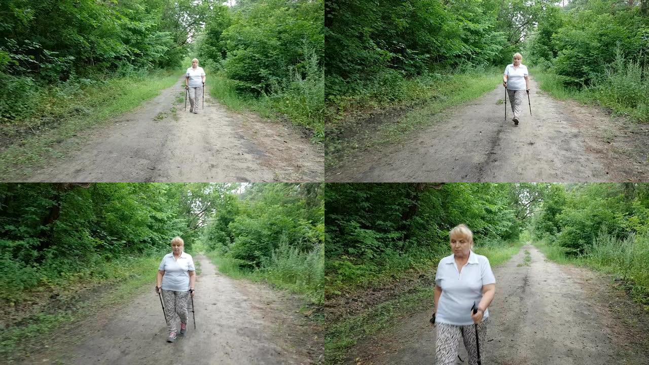 成熟的女人散步北欧散步，夏天在公园里。健康的生活方式。