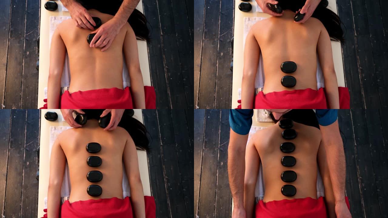 男按摩师为一个亚洲外貌的女孩做背部按摩。放松和滋补按摩