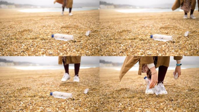 细心的女人在海洋沙滩上收集丢弃的垃圾