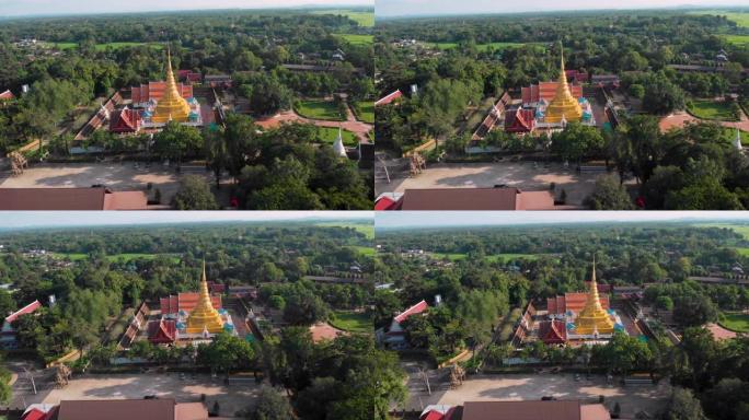 4k空中无人机拍摄-晴天的泰国佛教寺庙，绿树环绕的金色宝塔，红色屋顶，泰国文化，宗教信仰冥想，历史场