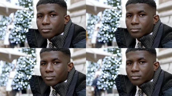 圣诞节期间，城市里年轻的严肃黑人盯着相机