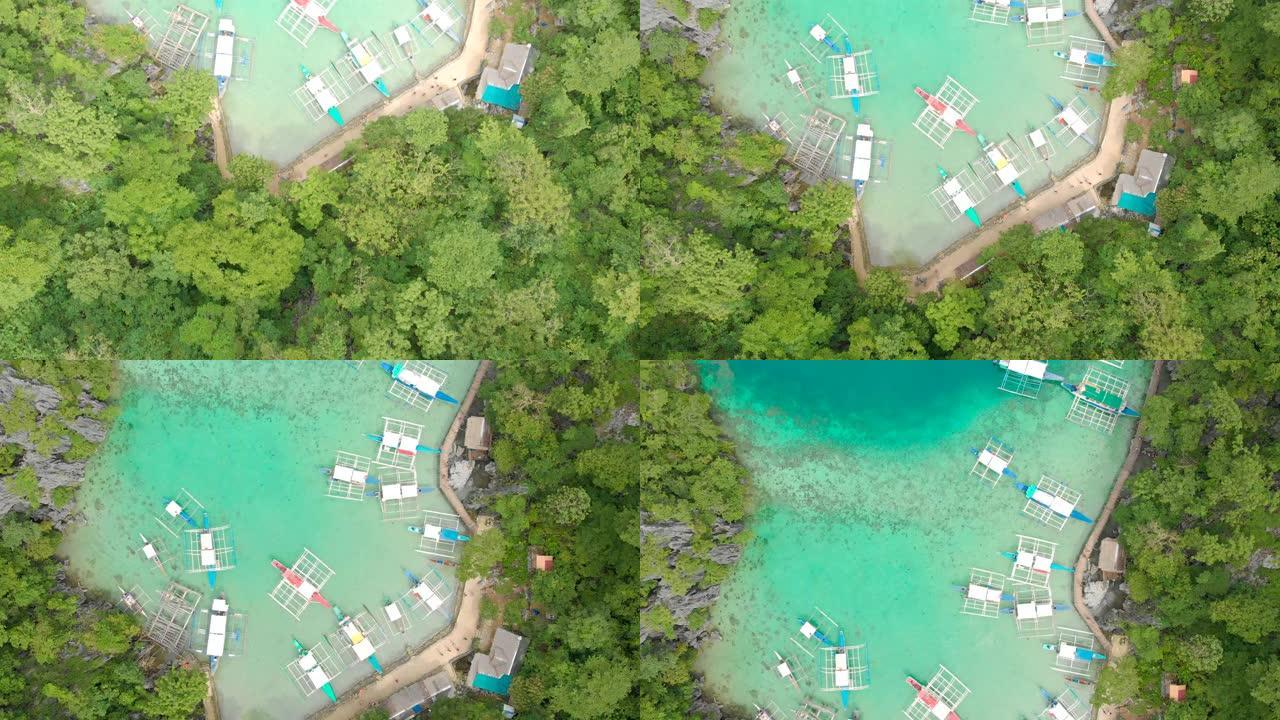 菲律宾巴拉望科伦岛Kayangan湖木码头上的船只在天堂湾蓝色水晶水的空中无人机视图。