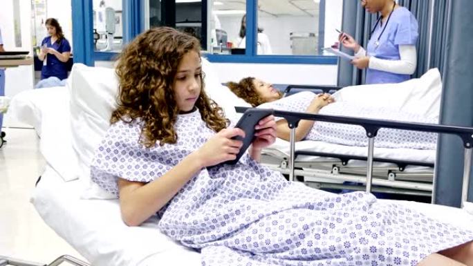 青春期女孩在急诊室等候时使用数字平板电脑打发时间