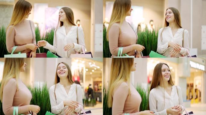 两个漂亮的年轻女子站在商场里，兴高采烈地聊天，大笑的慢动作镜头