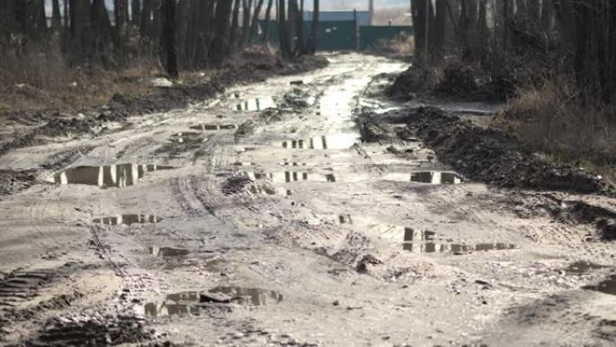 雨后破碎的坏土乡村土路里有很多泥泞的水坑。运动4k视频，4096x2160镜头