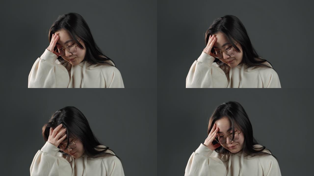 年轻的亚洲女人做脸脸手势的肖像，就像不，我忘了。长发不快乐的韩国女人感到悲伤，遗憾，戏剧，失败。我她
