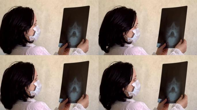 戴着医用口罩的女人正在看x射线
