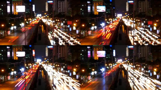 夜间城市路灯，城市交通和散焦汽车灯的延时镜头。黑暗时期有明路的快速行驶汽车