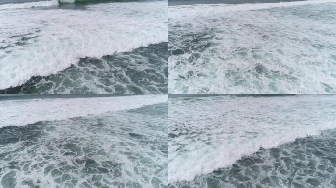 航拍画面，无人机海浪和冲浪者在印度洋冲浪的俯视图，4k