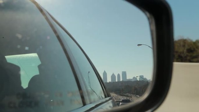 在高速公路上行驶并向后看后视镜
