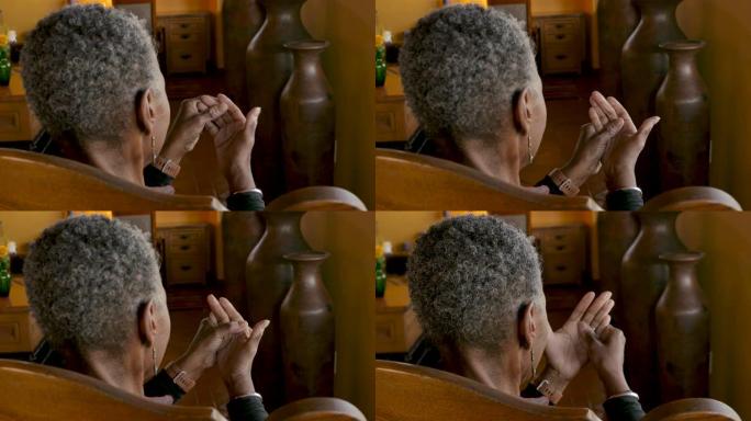 非裔美国高级黑人妇女揉搓双手的关节