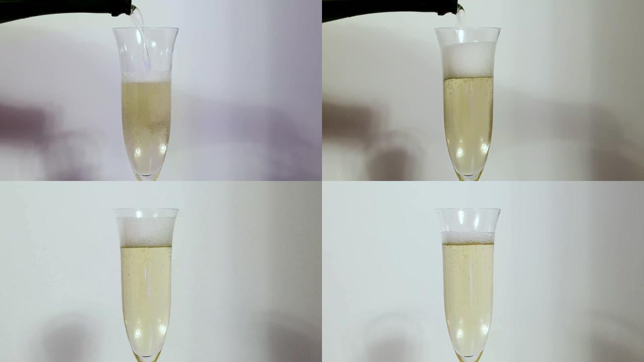 香槟被倒入背景玻璃杯中。美丽的背景。酒精概念。