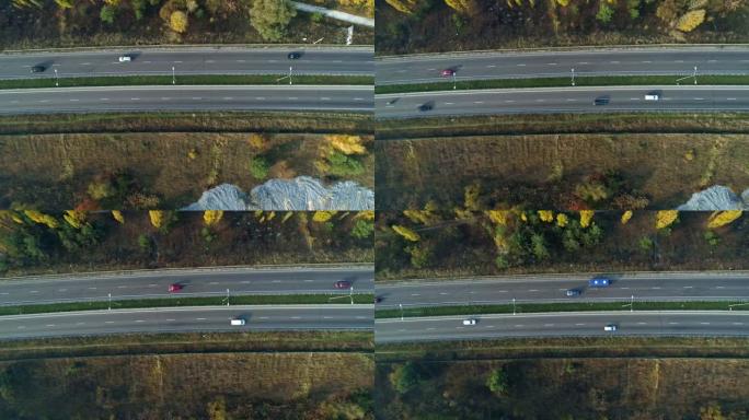 空中无人机镜头。飞越高速公路附近的森林顶景拍摄。